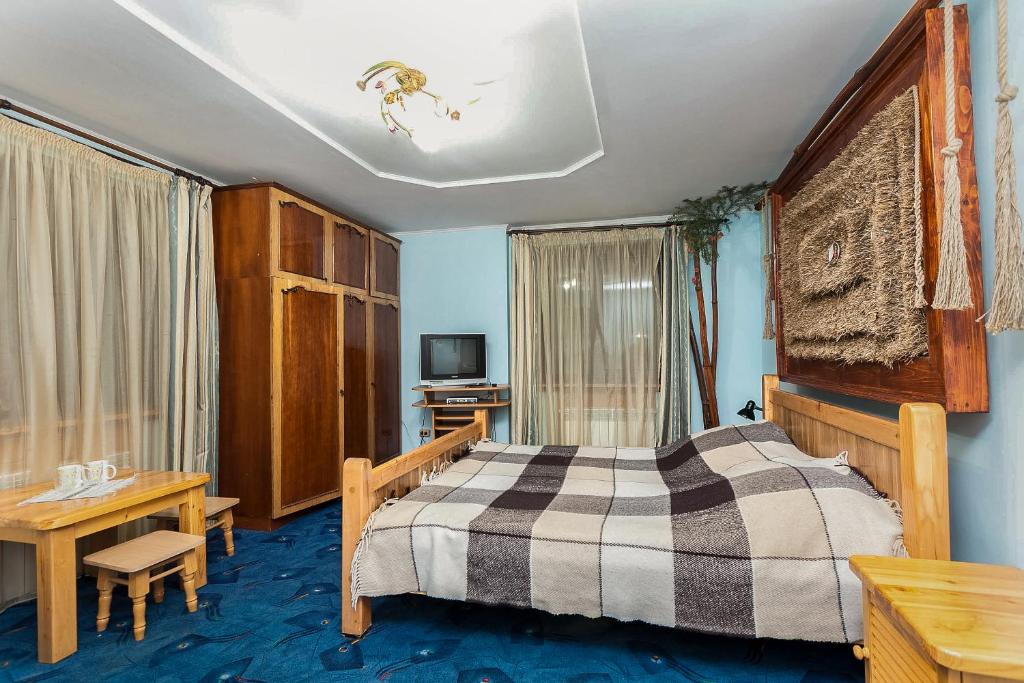 Postel nebo postele na pokoji v ubytování Vatra Hotel