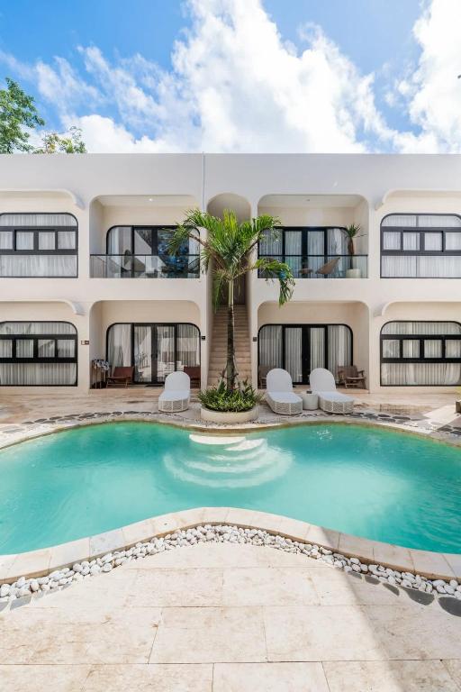 a house with a swimming pool in front of it at Modern 1BR with Spacious Living Room in Uluwatu