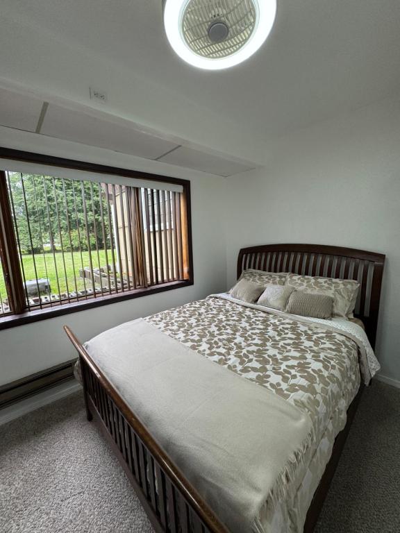 a bedroom with a large bed and a large window at Anchorage Fireoved Home Theater Experience in Anchorage