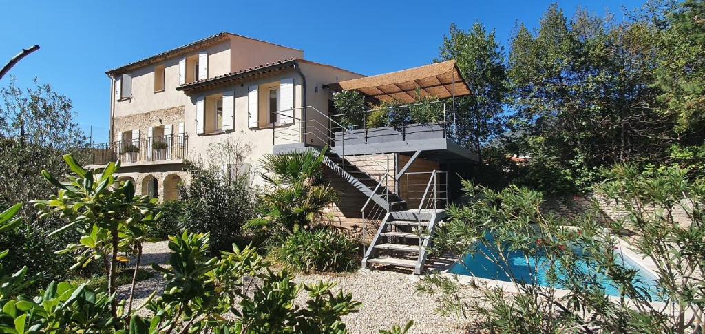 a house with a staircase leading up to a building at La Pastorale in Nyons