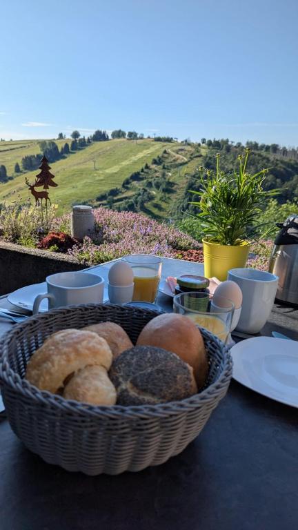 a basket of bread on a table with a view at Traumblick in Sankt Andreasberg