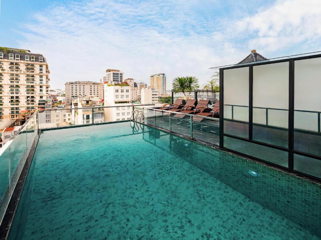 a swimming pool on the roof of a building at THE LEGEND HANOI Hotel in Hanoi