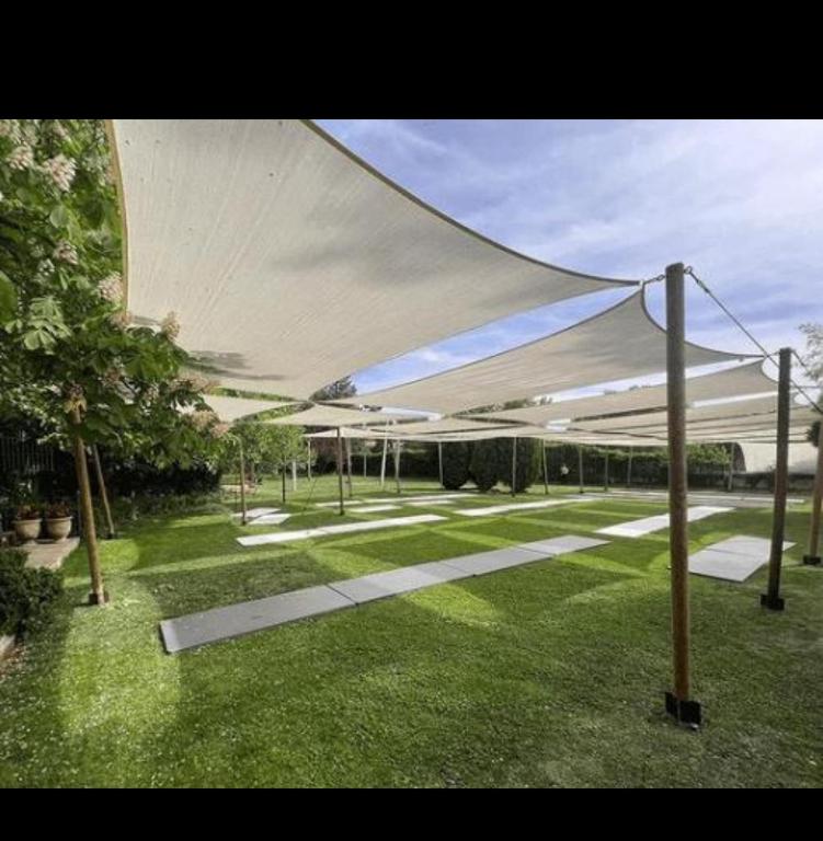 a large white canopy over a green field of grass at Dpr h in Aburi