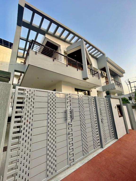 a house with a fence in front of it at ZenRoofs-3 BHK Bungalow in Jaipur