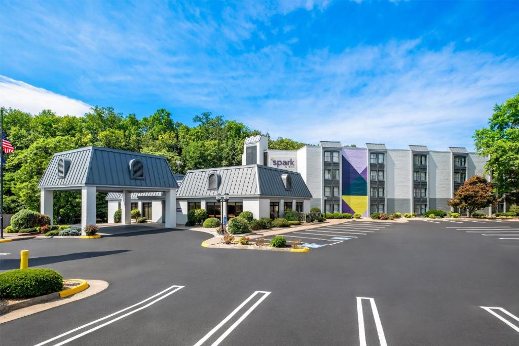 an empty parking lot in front of a hotel at Spark By Hilton Staunton in Staunton