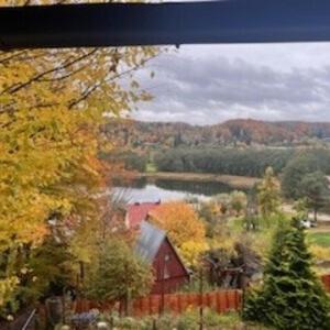 a view of a barn and a lake from a window at Ostrzycki Raj in Pierszczewo