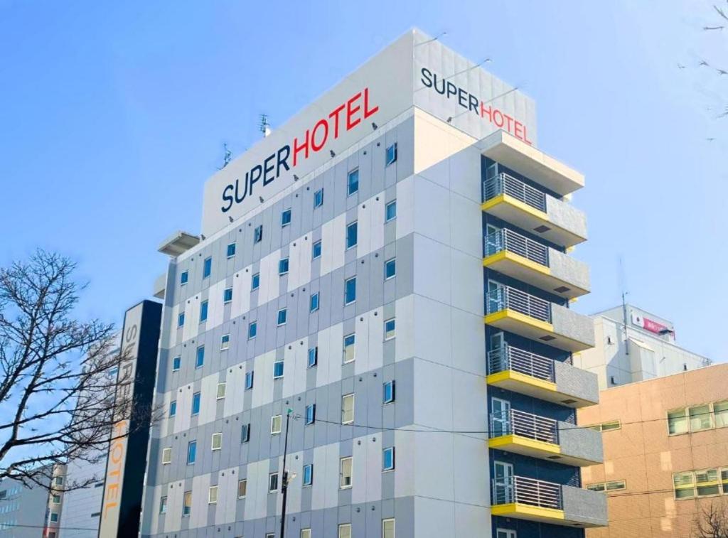 a building with a sign on top of it at Super Hotel Kushiro Kurogane in Kushiro