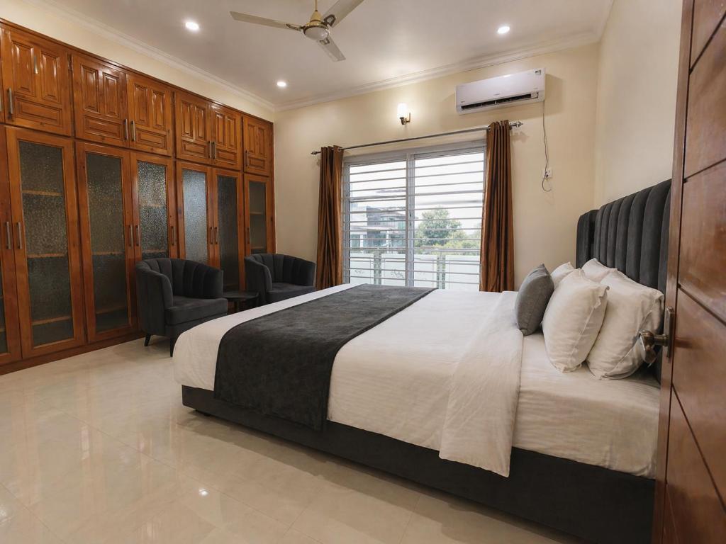 a bedroom with a large bed and a window at Studio 13 in Islamabad