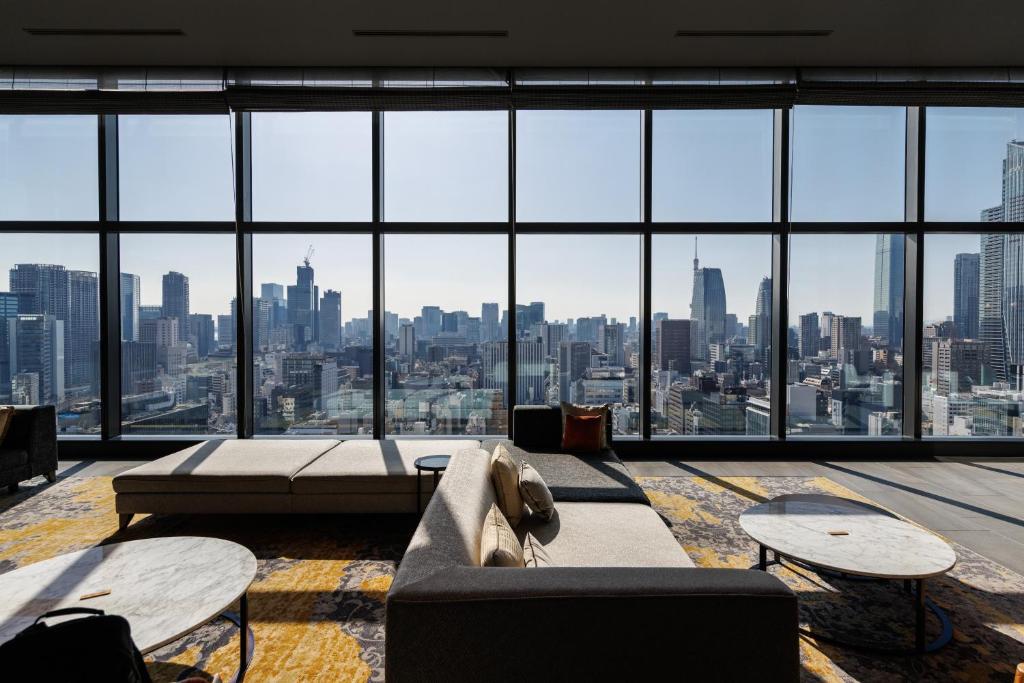 a living room with a view of a city at THE BLOSSOM HIBIYA in Tokyo