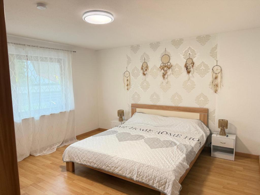 a bedroom with a bed in a room with a window at Wohnen am Rande des Schwarzwaldes in Eggingen