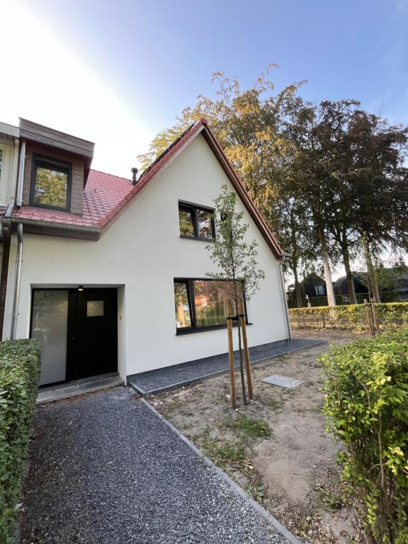 a white house with a garage at Villa Médard in Bruges