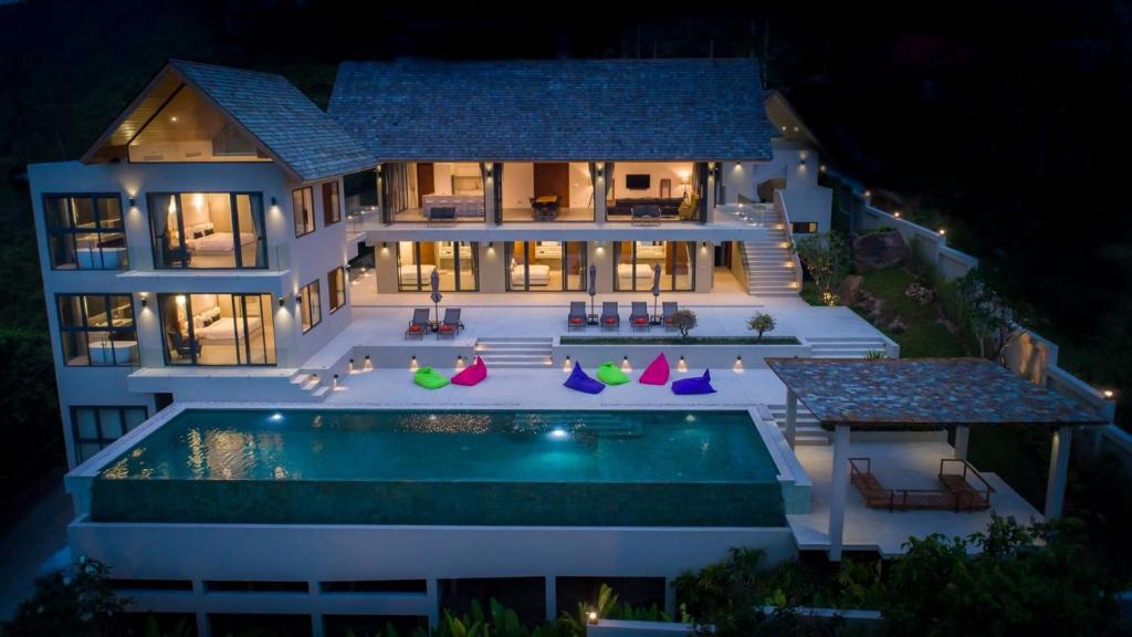 an aerial view of a house at night with a swimming pool at Nojoom Hills - Sea View 6 Bedroom Villa in Bophut 