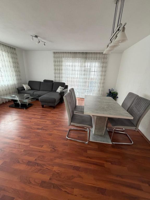 a living room with a table and a couch at Ferienwohnung Olpe in Olpe