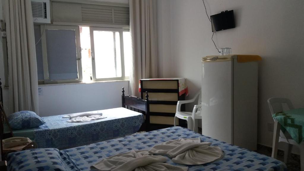Postel nebo postele na pokoji v ubytování Britânia Hotel