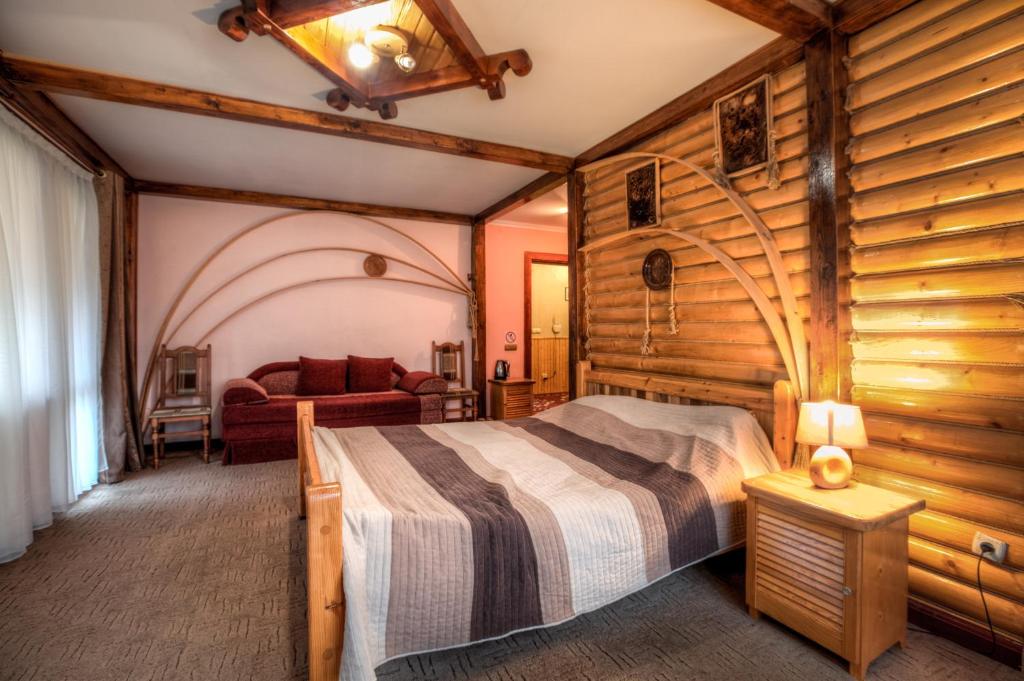 Postel nebo postele na pokoji v ubytování Vatra Hotel