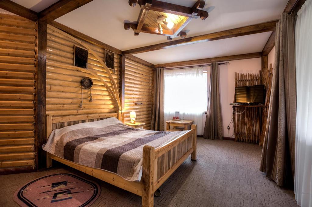Postel nebo postele na pokoji v ubytování Vatra Hotel