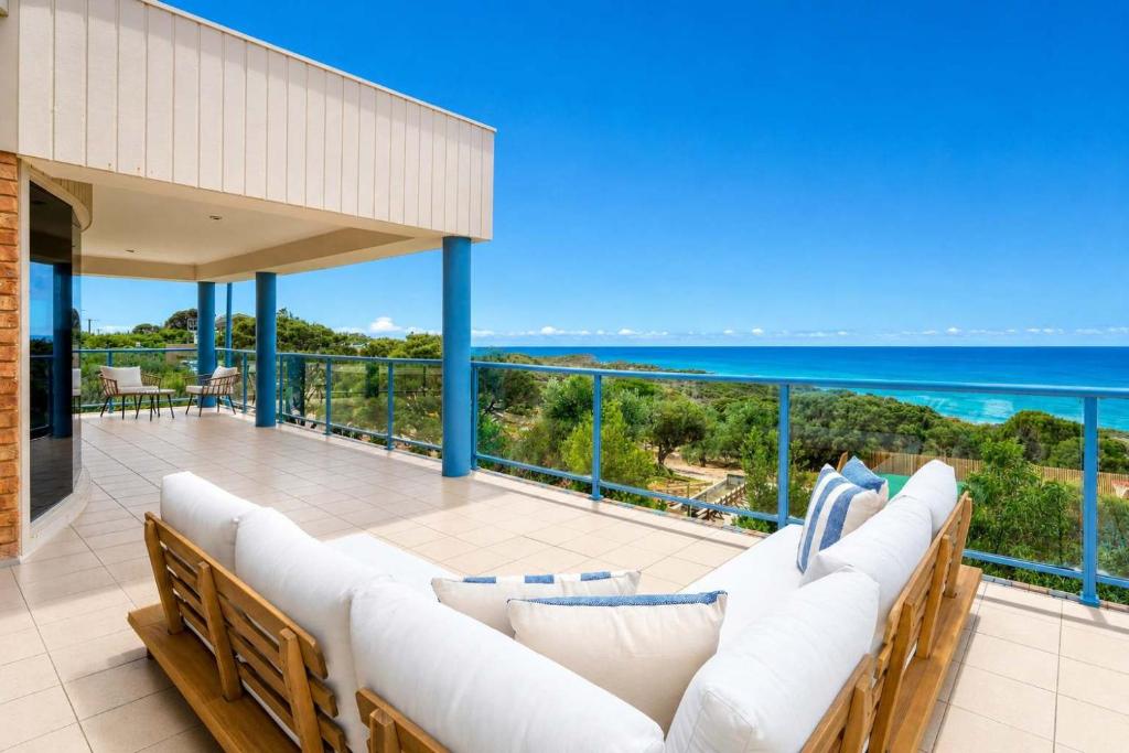 a patio with white couches and the ocean at Ultimate Ocean Views - Pet Friendly in Bellbrae