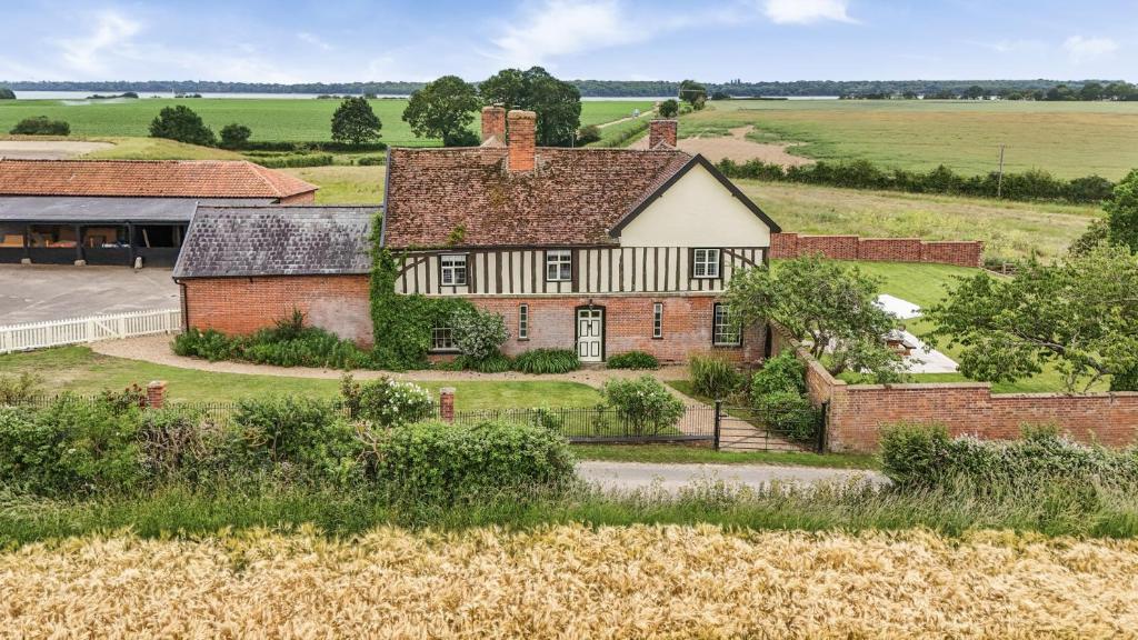 an aerial view of an old house in a field at Knights Farm in Ipswich