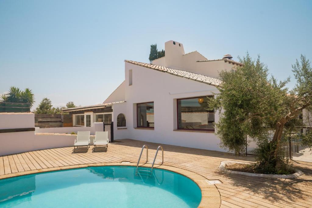 a villa with a swimming pool and a house at L'Oustau des Palunettes Concept Adulte only in Saintes-Maries-de-la-Mer