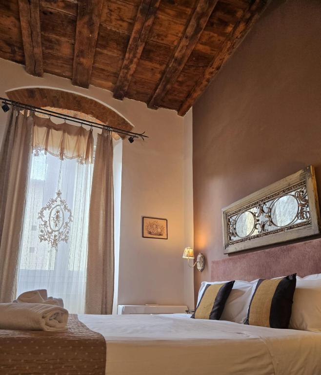a bedroom with a bed and a window at B&B Cimatori in Florence