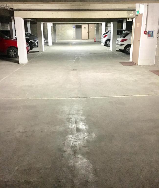 an empty parking garage with cars parked in it at Hôtel Ulysse Montpellier Centre in Montpellier