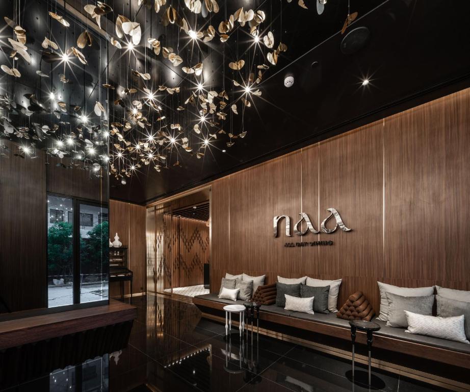 A dark, theatrical lounge with a long cushioned banquette.