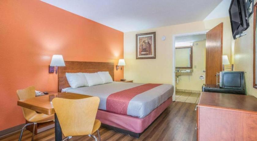 a hotel room with a large bed and a desk at Rodeway Inn & Suites in Lakeview