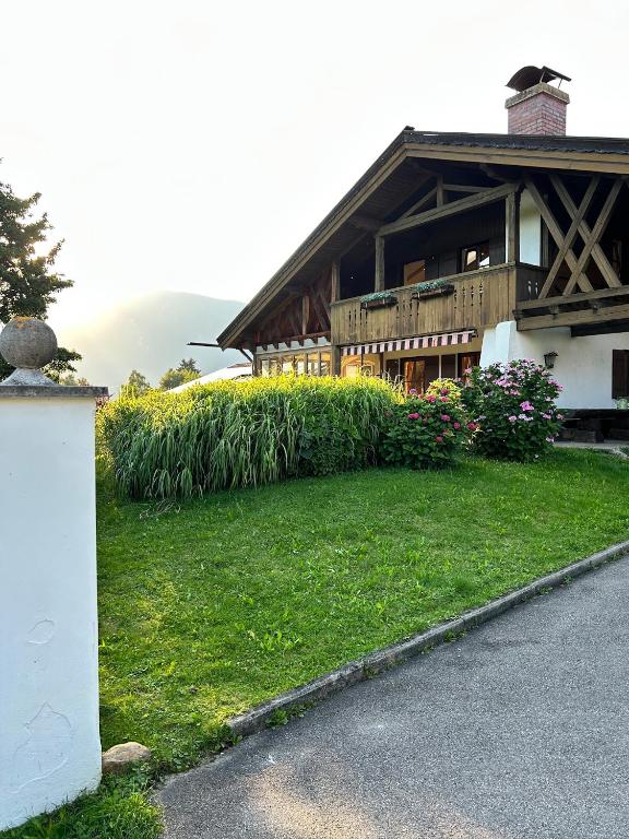 a house with a green lawn in front of it at Ferienhaus am Hochgern in Unterwössen