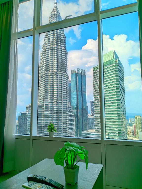 a view of a city skyline from a window at Sky Suites KLCC Kuala Lumpur LB in Kuala Lumpur