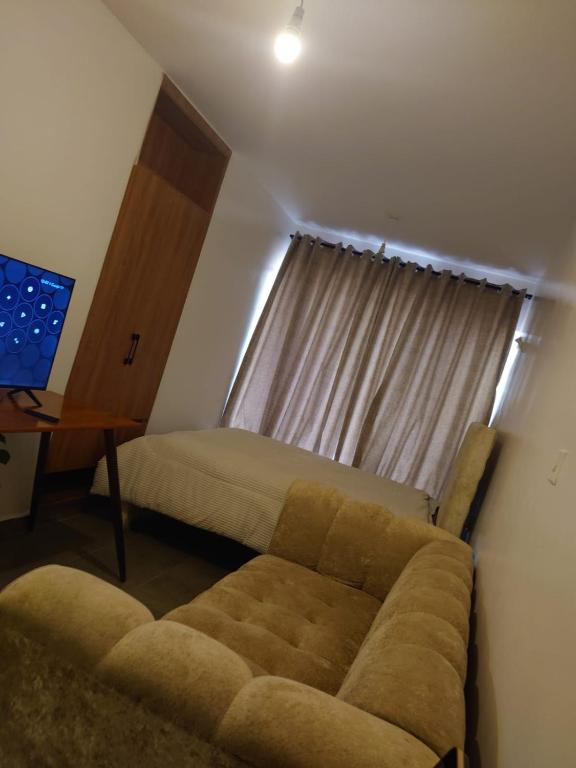 a living room with a couch and a window at A006 Ss2 in Kiambu