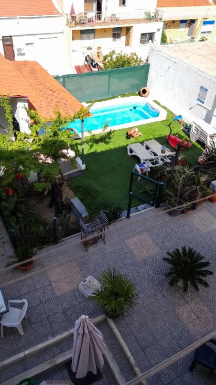 an overhead view of a backyard with a swimming pool at Comfortable Apartment in Feijó with Shared Pool, 90 m² in Almada