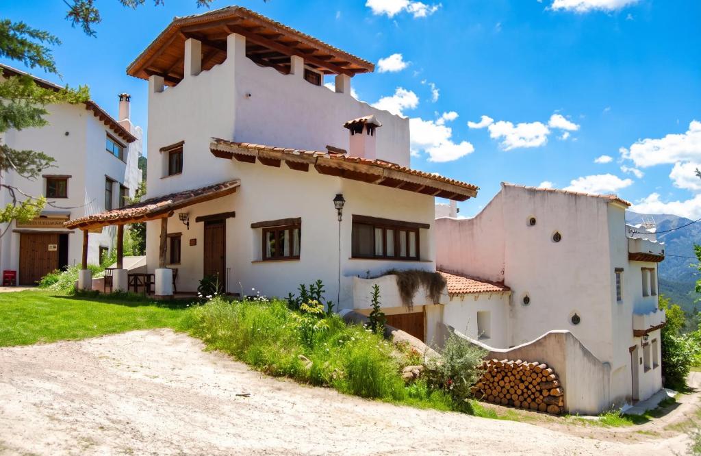 a large white house with a dirt road in front at Spacious Apartment in Yeste with Shared Pool in Yeste