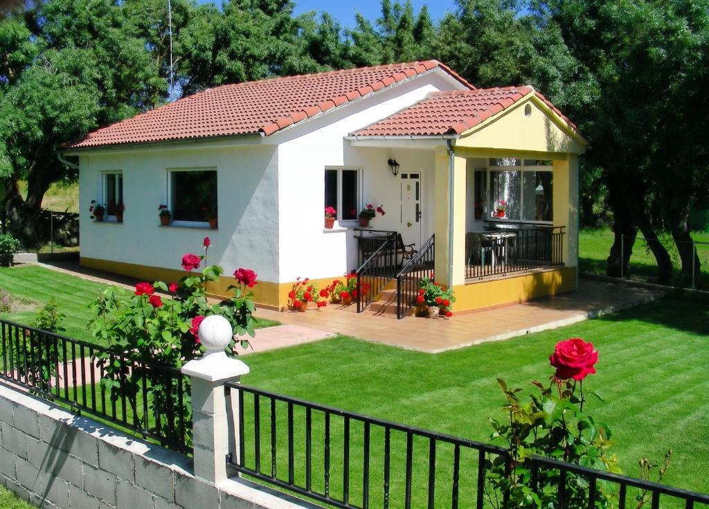 a small white house with a fence at Charming Villa with Private Pool in La Calzada de Béjar in La Calzada de Béjar