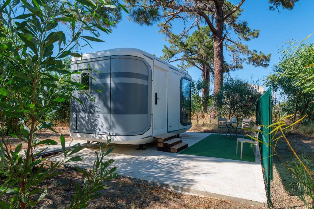 a caravan is parked in a garden at Futura 2 in Borgo