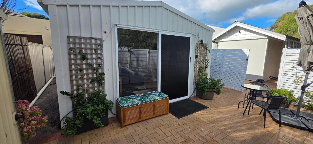a patio with a door and a table and chairs at Studio in Quindalup bay in Quindalup