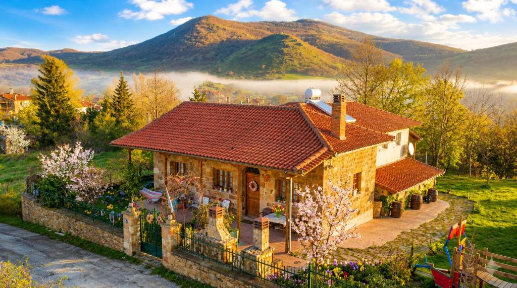 a house with a red roof in the mountains at Kirki Old Winery Guest House in Kírki