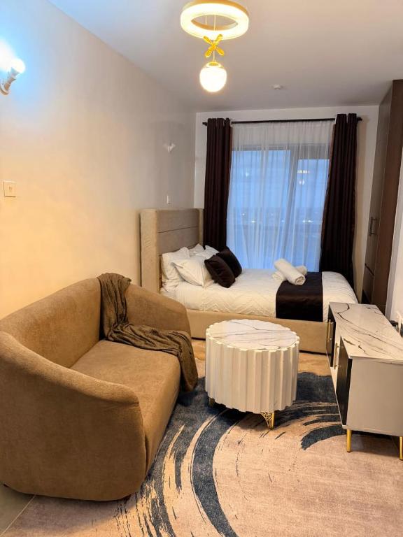 a living room with a couch and a bed at Tsavo rising in Nairobi