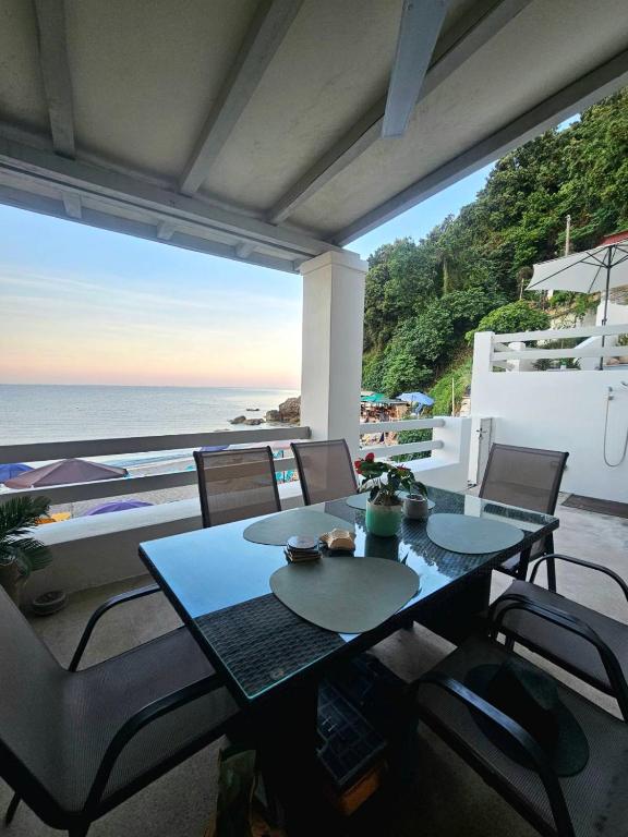 a patio with a table and chairs and the ocean at Villa Aktaia in Keramídhion