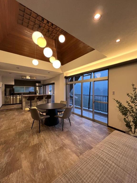 a large living room with a table and chairs at VILLA VINO ATAMI m in Atami