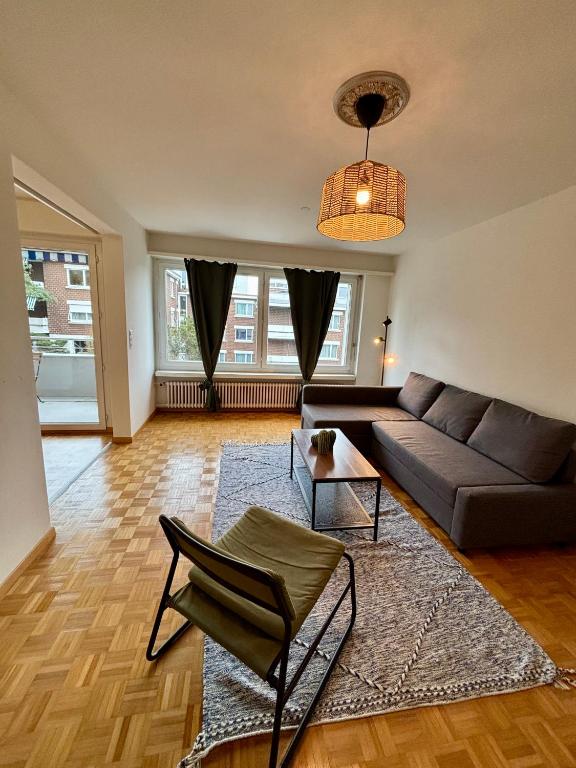 a living room with a couch and a table at Basic Apartment in Witikon district in Zurich