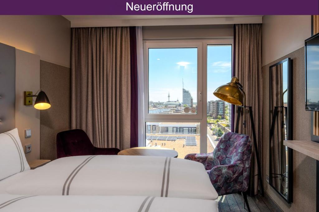a hotel room with a bed and a large window at Premier Inn Bremerhaven in Bremerhaven