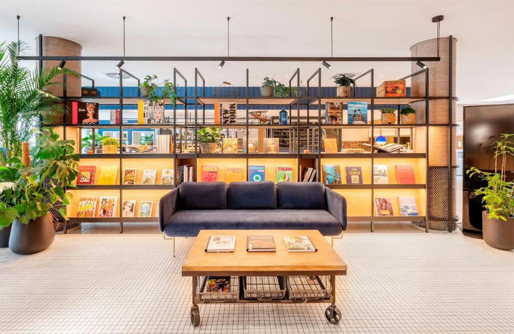 a living room with a couch and a coffee table at INNSiDE by Meliá Berlin Mitte in Berlin