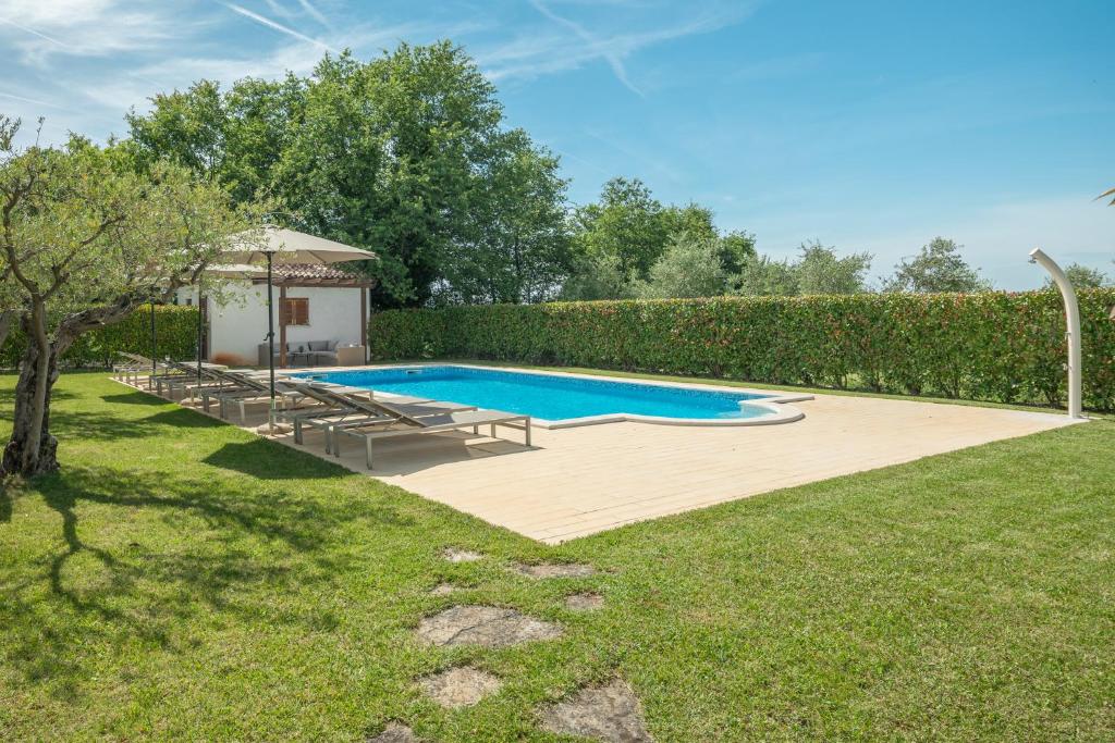 a swimming pool in a yard with a gazebo at Apartment Complex Vetrina-Shared Pool in Nova Vas