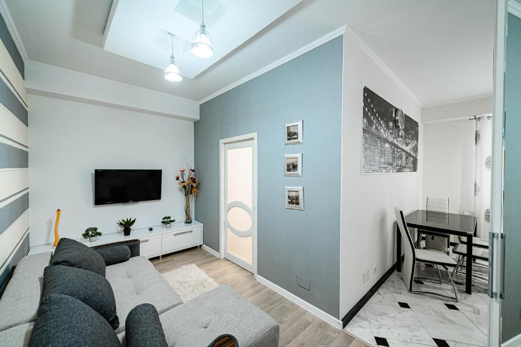 a living room with a couch and a table at Urban Nest in Chişinău