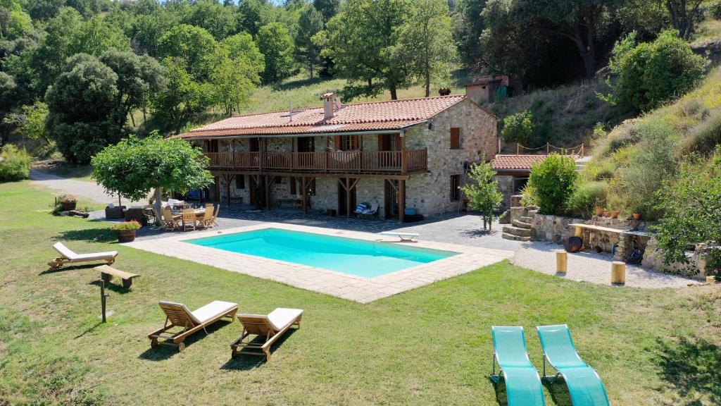 an aerial view of a house with a swimming pool at Mas Lartigues in Taurinya