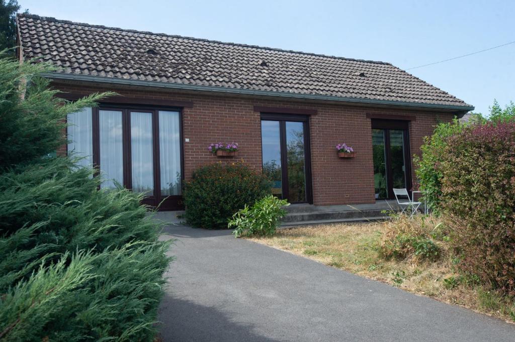 a red brick house with windows and a driveway at La Pierraille in Froid-Chapelle