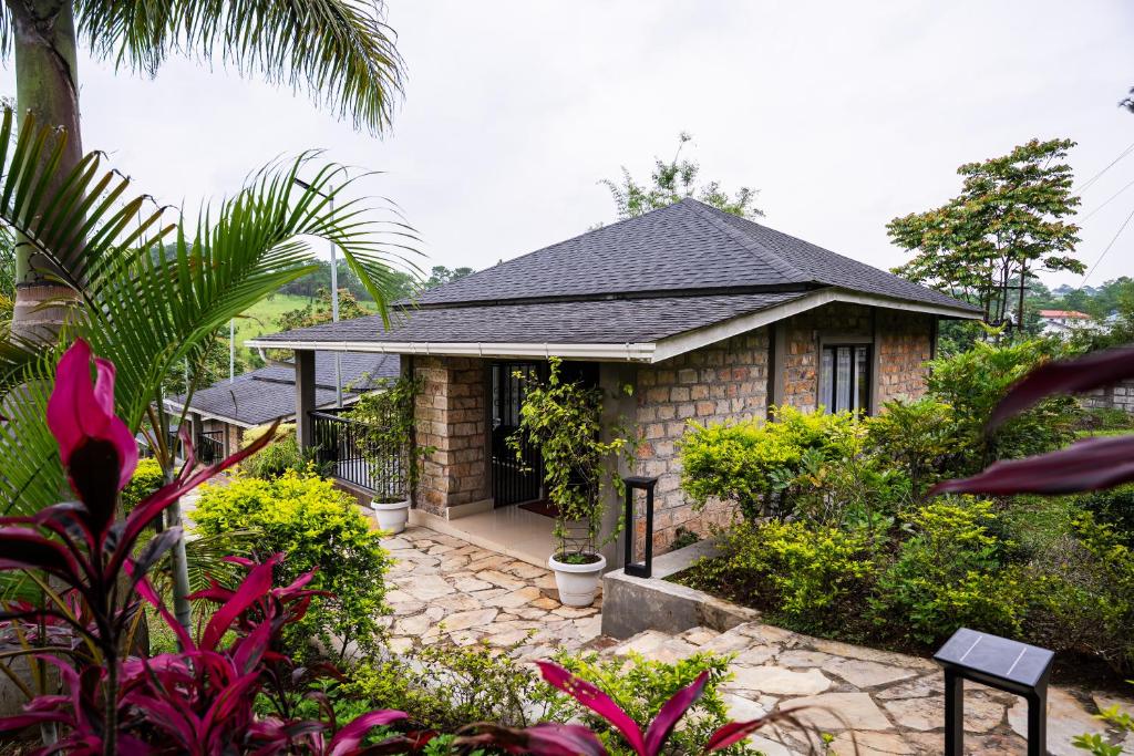 a small house with a garden in front of it at Nohsngithiang Estate in Borpāni