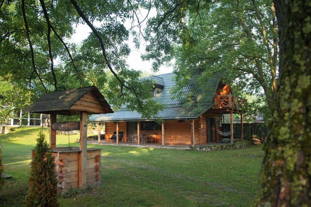 a log house with a gazebo in the yard at Bondyrz 134 in Bondyrz