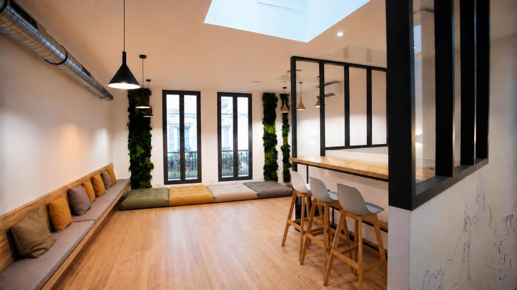 a living room with a bar and some chairs at Espace entier Centre de Paris in Paris