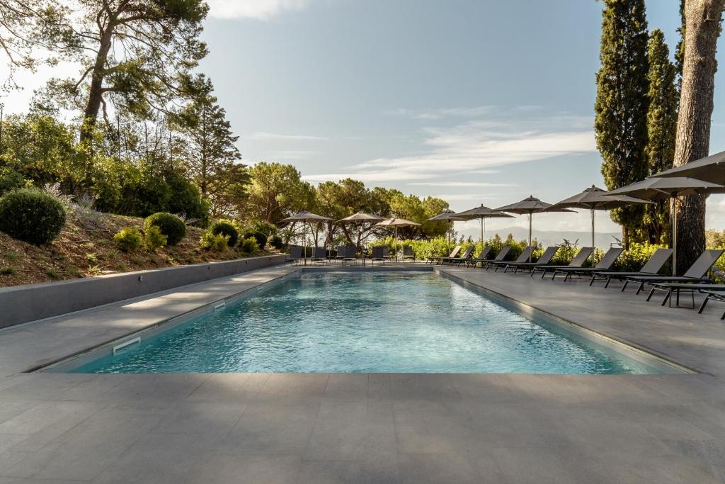 a pool with chairs and umbrellas at a resort at Grand Hotel San Gemini I UNA Esperienze in San Gemini